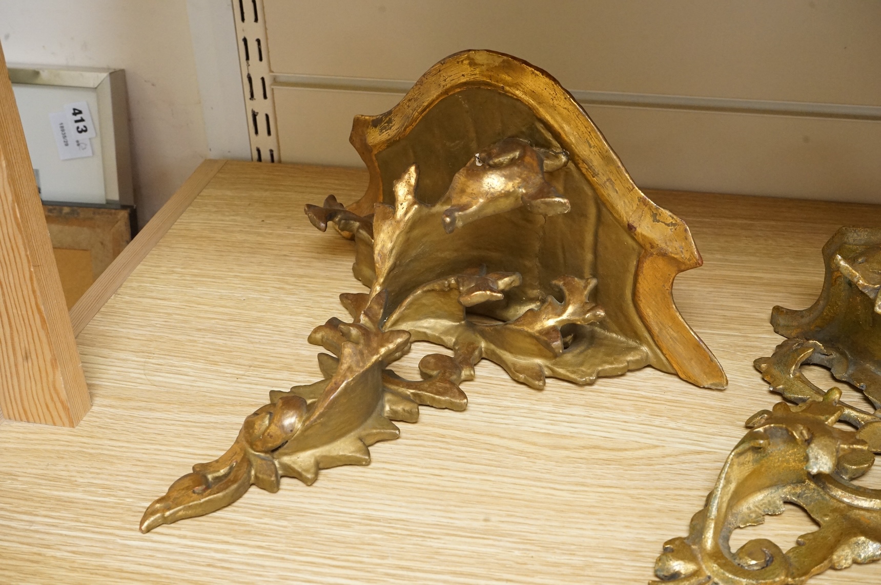 A large giltwood wall bracket- 28cm high together with a smaller similar wall bracket.